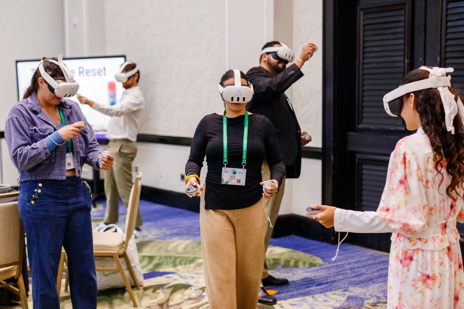 Teachers trying out VR headsets at the Spring Educators Conference held at the Wyndham Grand Rio Mar in Rio Grande, Puerto Rico.