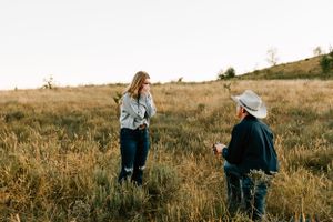 A cowboy proposes to his girlfriend in a field at his family ranch in Caney, Kansas.