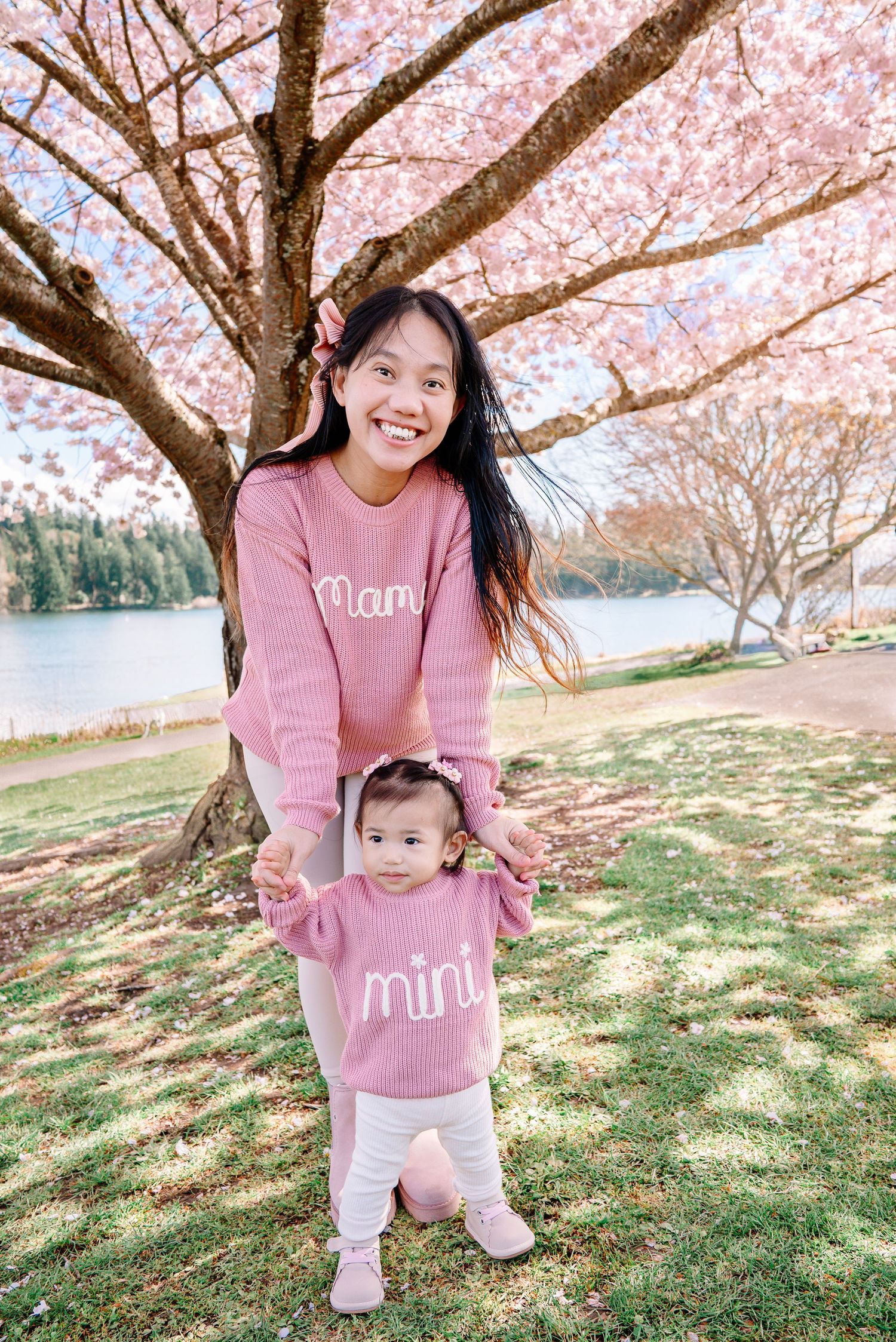 Mother and child playing under cherry blossoms in Seattle, beside Lake Washington and near Seward Park.