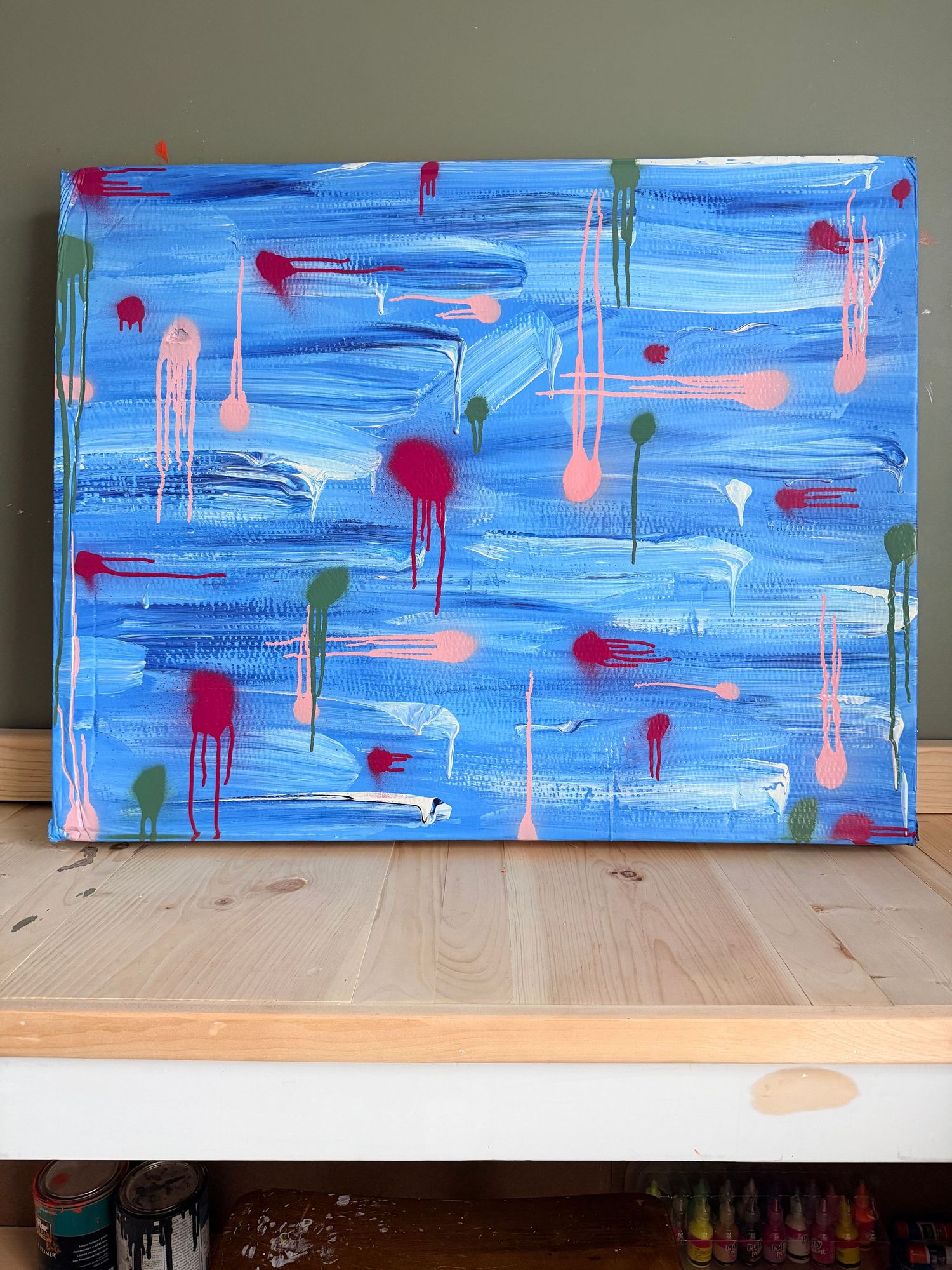 Vibrant psychedelic eye painting on black canvas with yellow, blue, and red abstract patterns in a wooden frame.