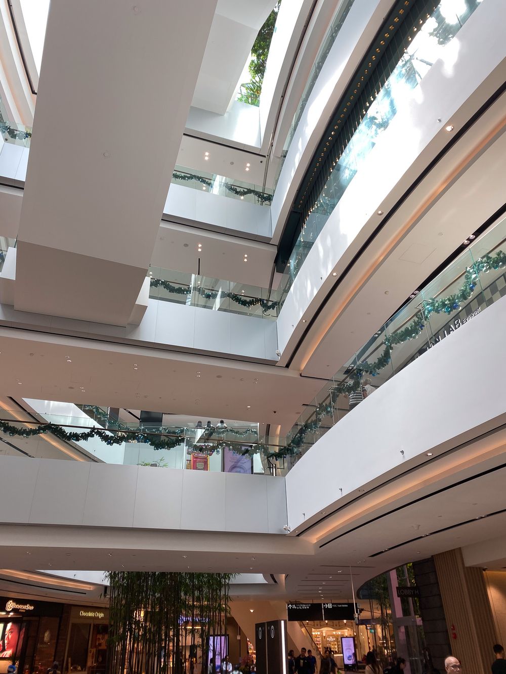 Changi Jewel, Singapore. Modern shopping mall interior with multiple floors, glass railings