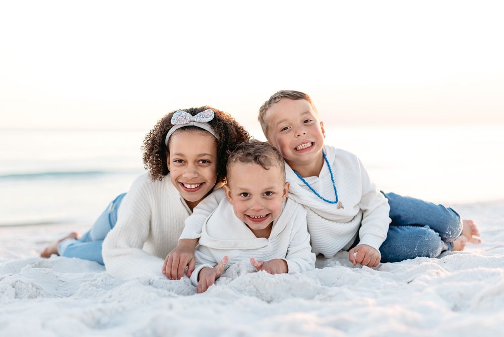 There children playing and laying in the sand during the cooler months of the holiday season in Destin Florida