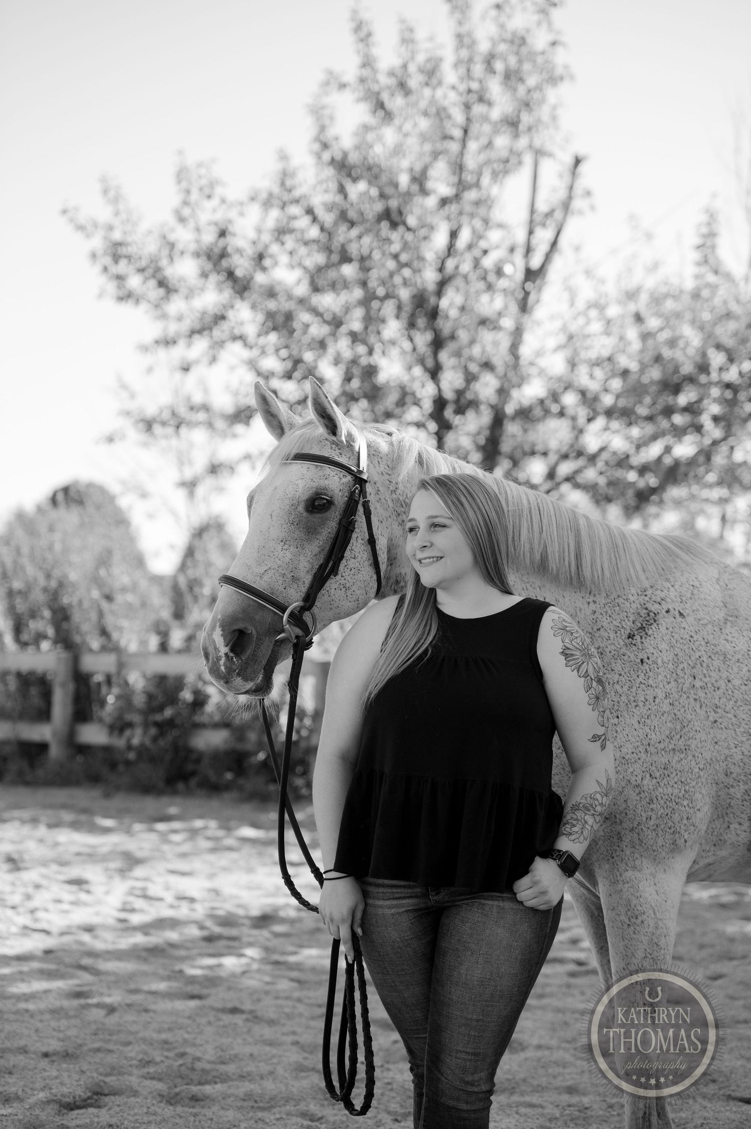 A black and white equestrian portrait showing a close bond between horse and owner.