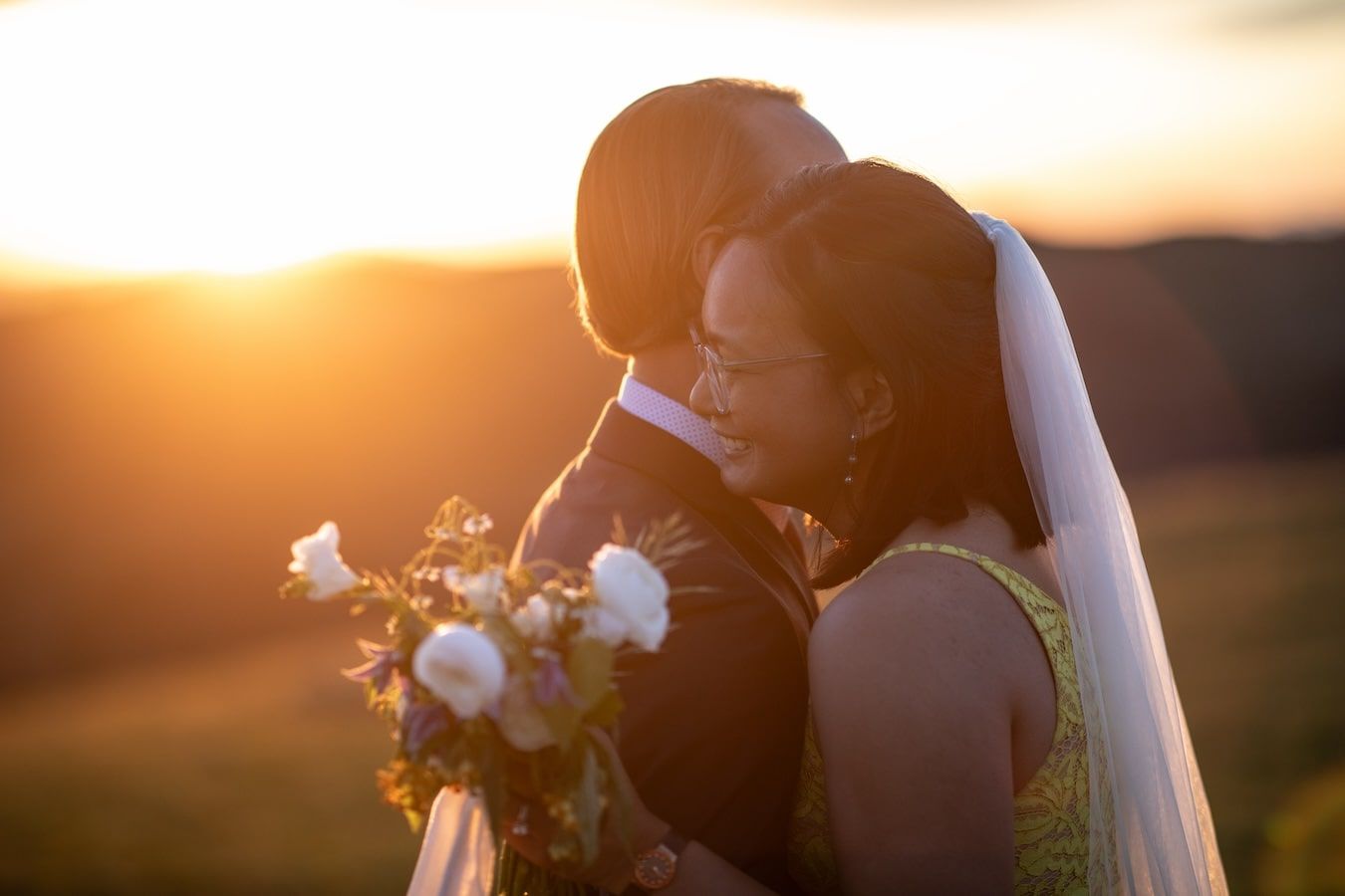 couple at sunset hugging