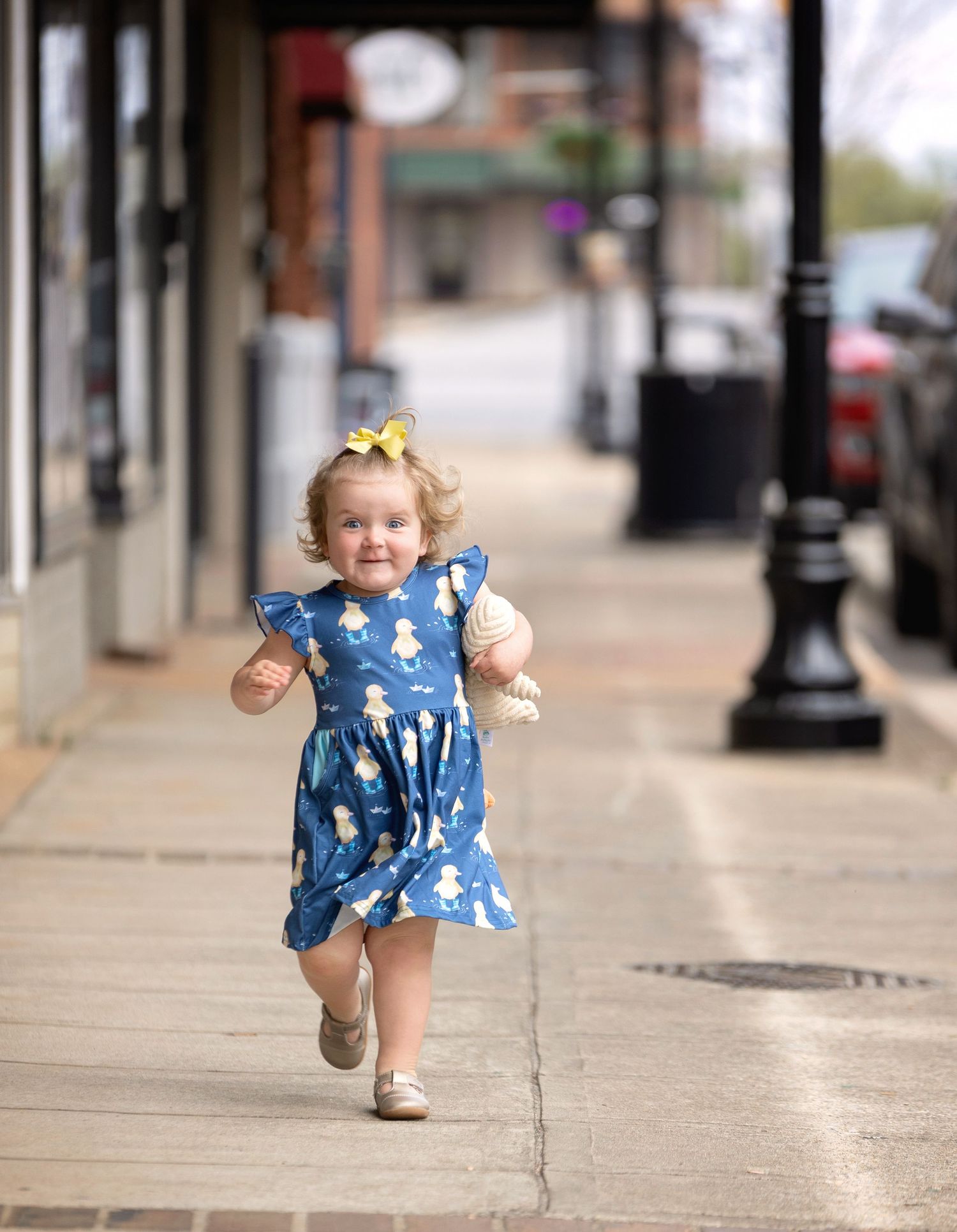 A two-year-old little girl with curls running. Greenville, SC newborn photographer. Easley, SC Newborn photographer