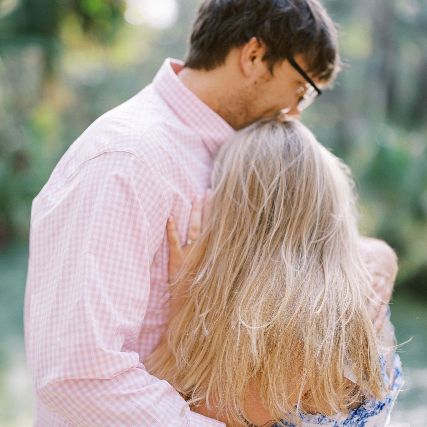 Romantic outdoor engagement portrait in soft natural lighting.