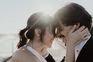Close-up of couple holding hands by the lighthouse – alternative wedding