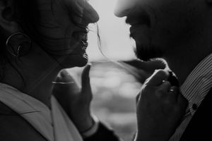 Couple laughing by the water – unposed wedding photography