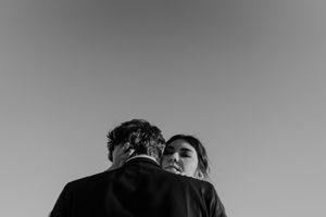Couple laughing by the water – unposed wedding photography