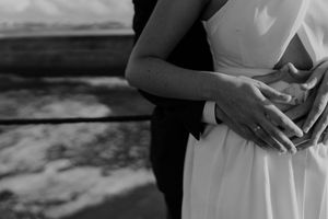Close-up of couple holding hands by the lighthouse – alternative wedding