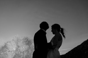 Close-up of couple holding hands by the lighthouse – alternative wedding