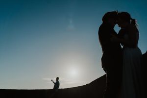 Close-up of couple holding hands by the lighthouse – alternative wedding