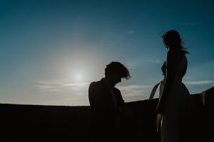 Close-up of couple holding hands by the lighthouse – alternative wedding