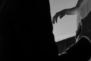 Close-up of couple holding hands by the lighthouse – alternative wedding