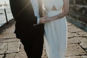 Couple walking along the rocks at sunset – elopement Portugal