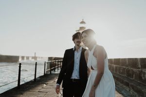 Couple walking along the rocks at sunset – elopement Portugal