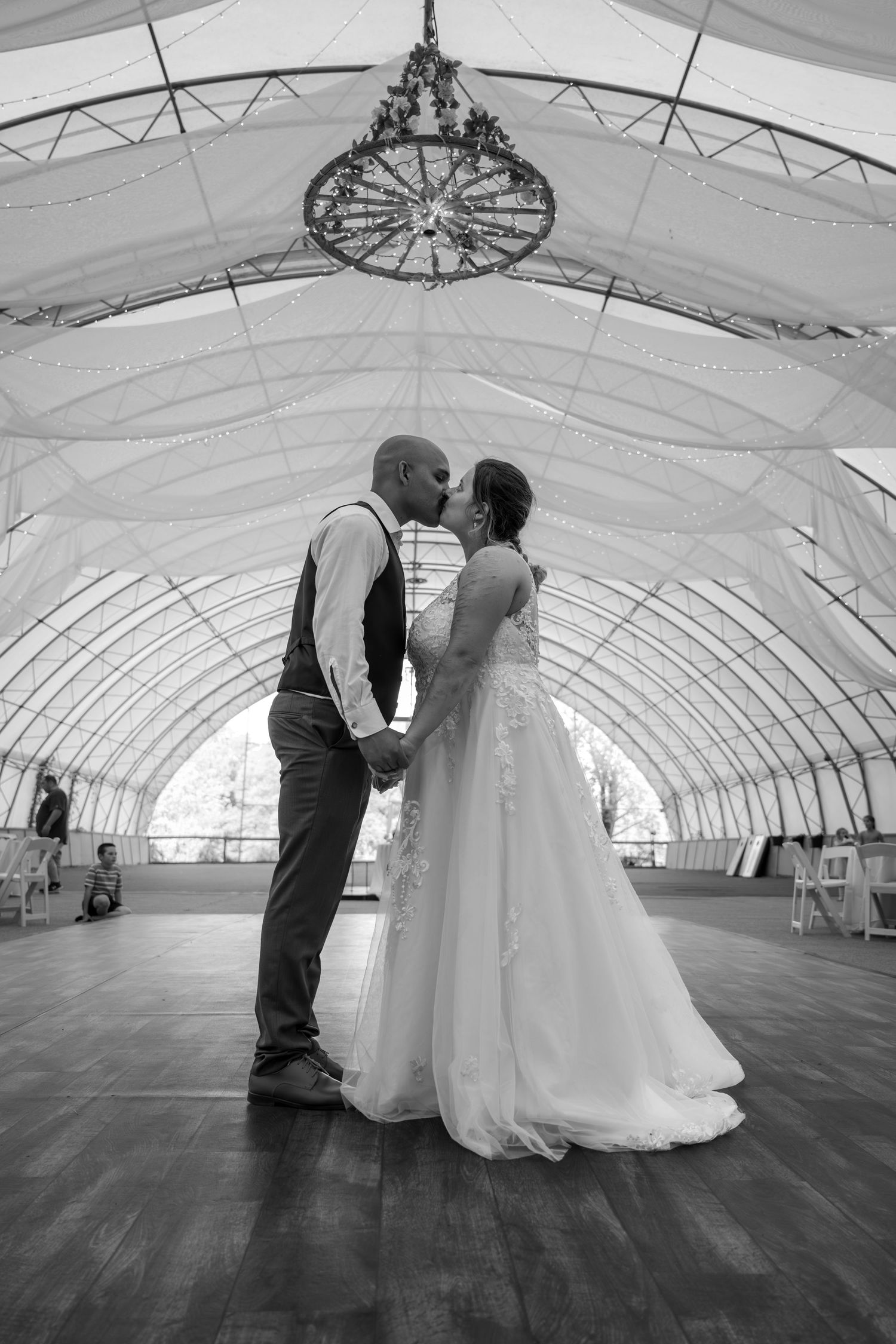 A romantic black and white photo sequence shows a couple in wedding attire sharing intimate moments on a dance floor.