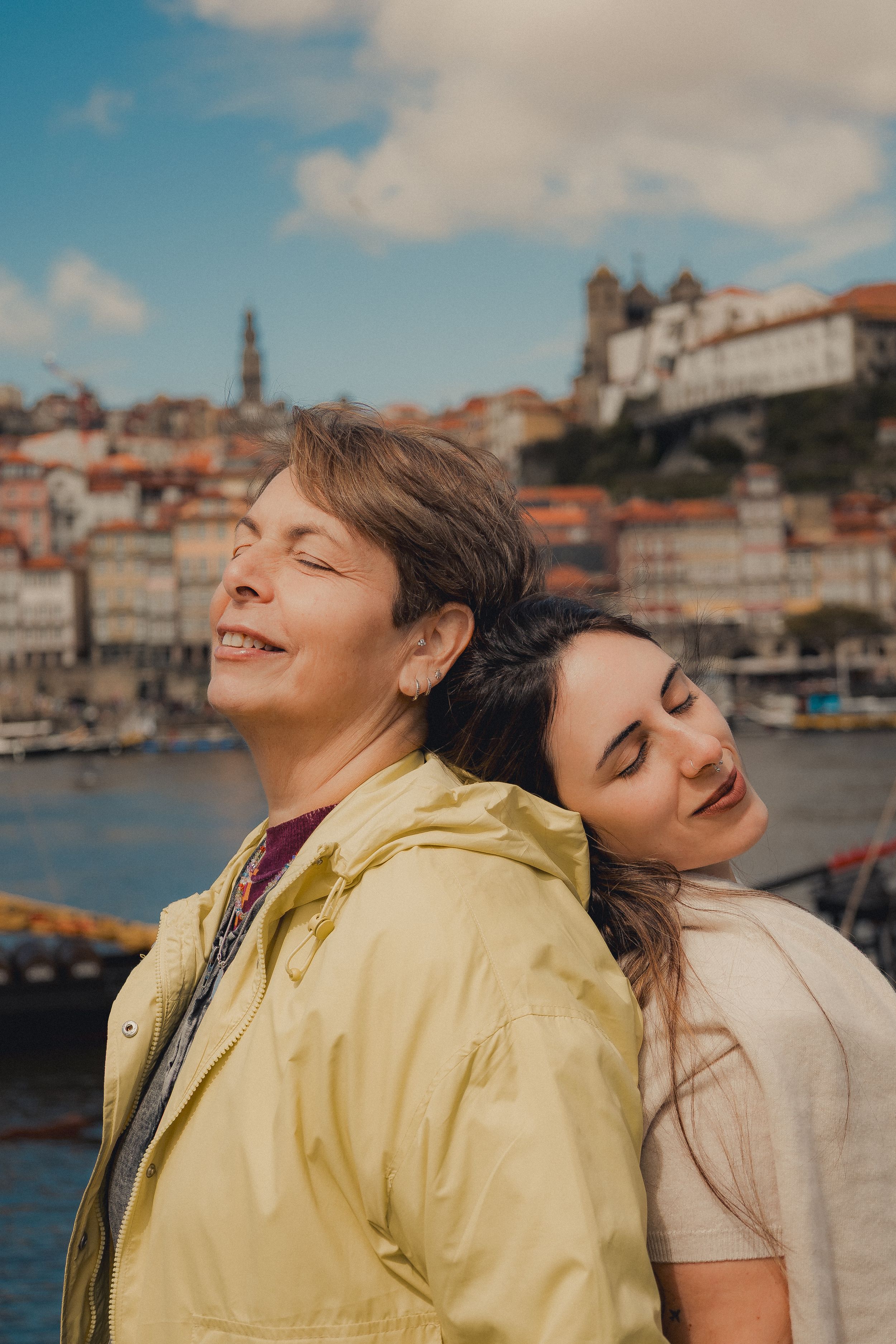 Two people enjoying view of Porto cityscape and river.