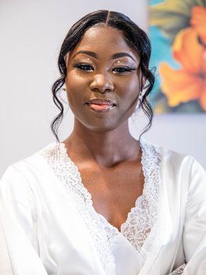 Beautiful portrait of someone wearing an elegant white lace-trimmed dress against a colorful floral background.