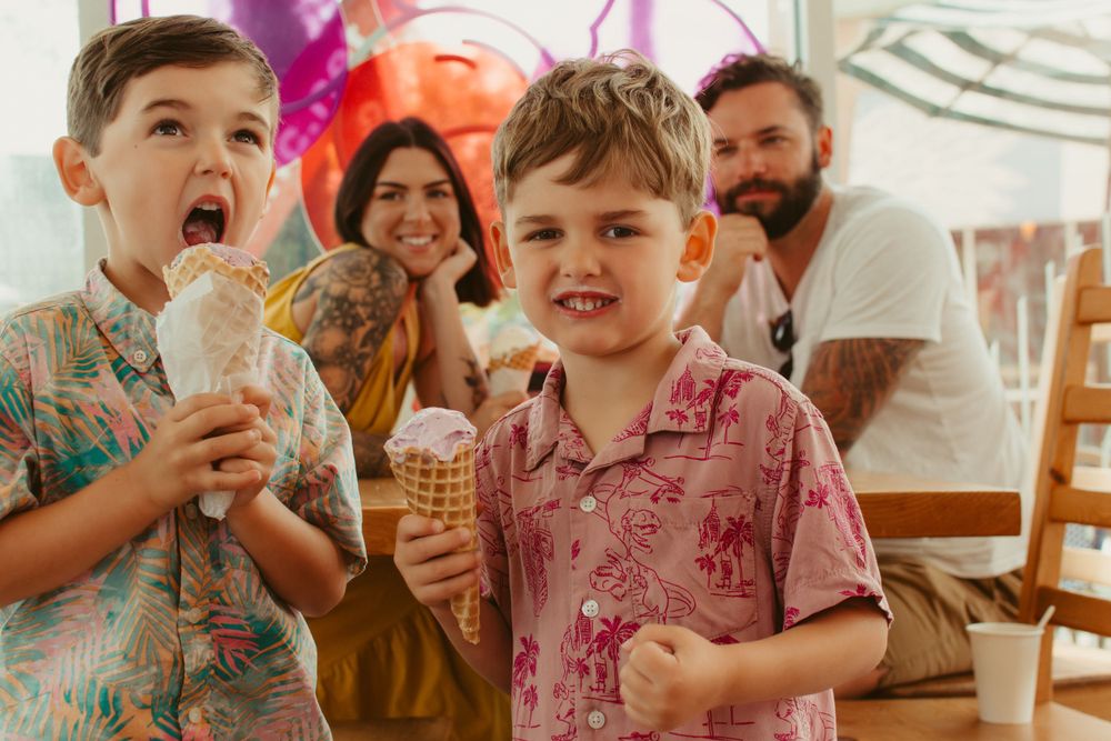 Family enjoying ice cream treats together at a casual dining establishment.