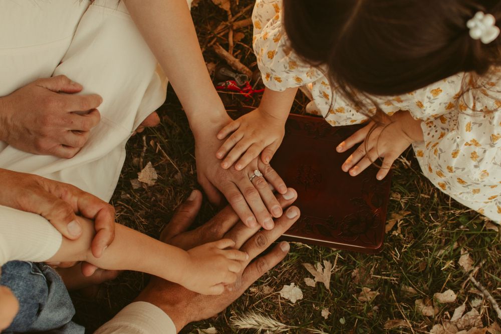 Multiple hands joining together on ground in unity and connection.