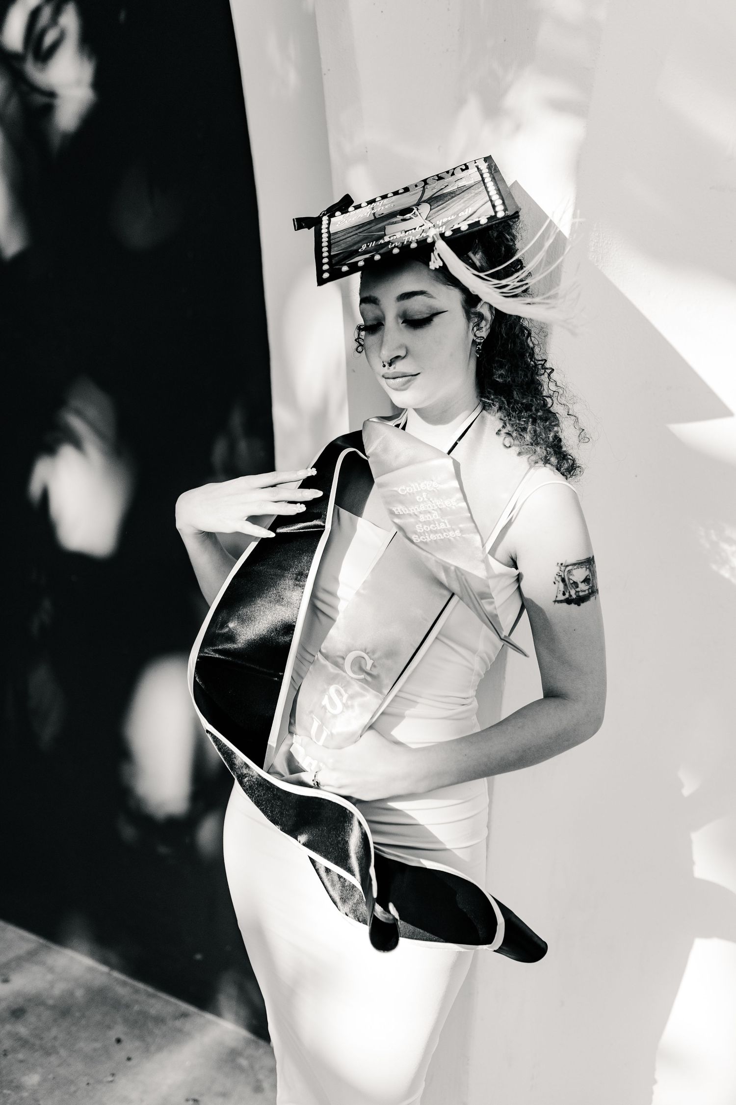 CSUF College Senior in grad cap and sash black and white