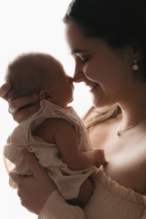 A series of backlit silhouette photos capturing tender moments between parent and infant.