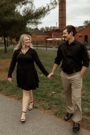 A couple holding hands while walking on a path near brick buildings, shown in a series of candid moments.