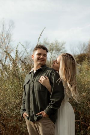 A joyful outdoor family photo session in nature with warm autumn tones and candid laughter.
