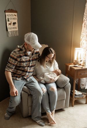 A series of four intimate photos showing a couple sitting together on a grey couch in a warmly lit room.