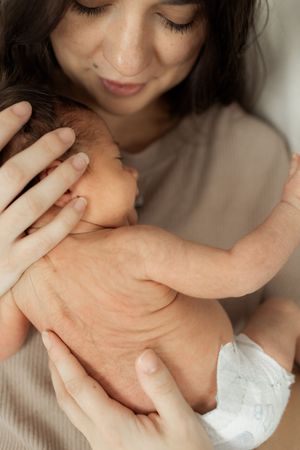 Close-up series of hands gently touching and caressing in intimate poses against a light background.