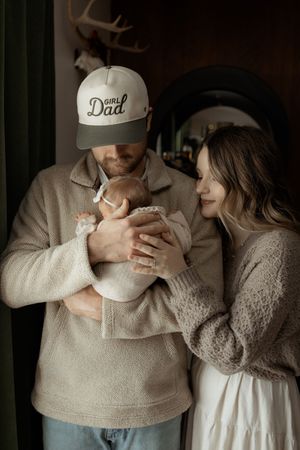 A series of intimate black and white photos showing tender moments between two people wearing neutral colored clothing.