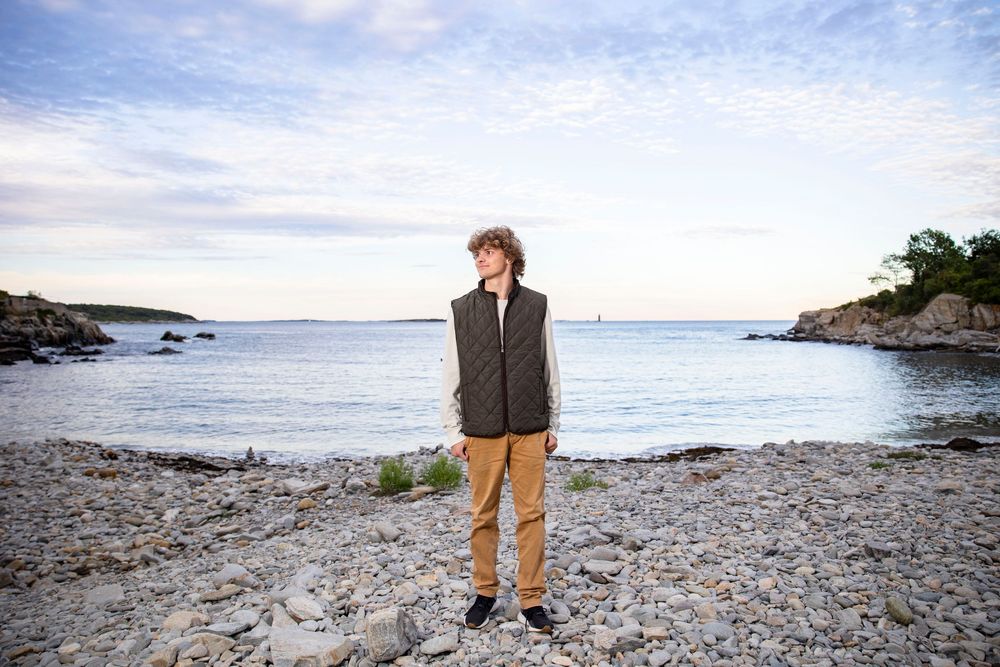 Senior portrait on the rocks at Fort Williams Park in Cape Elizabeth Maine.