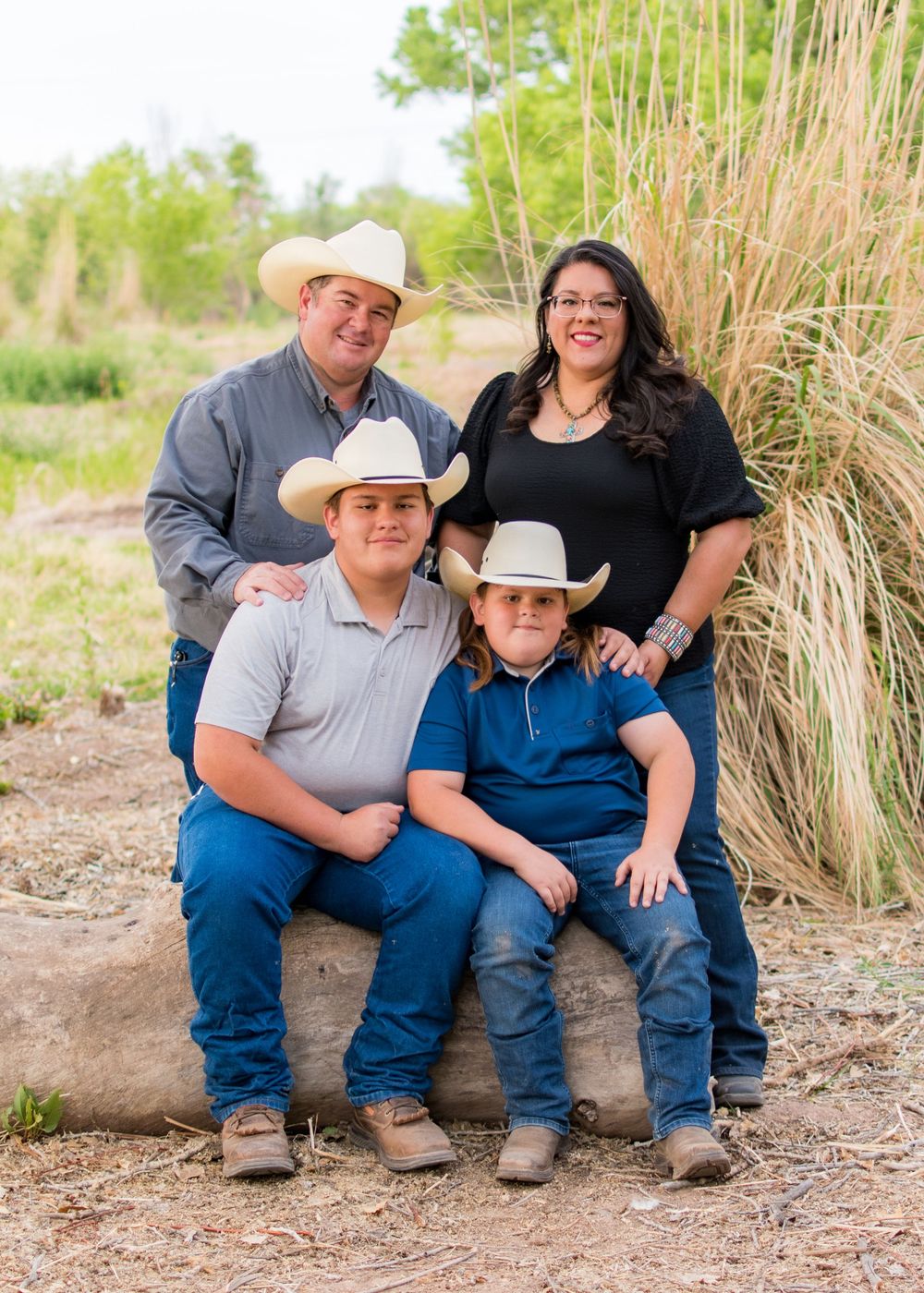 family photo, sitting/standing, cowboy hats, smiling