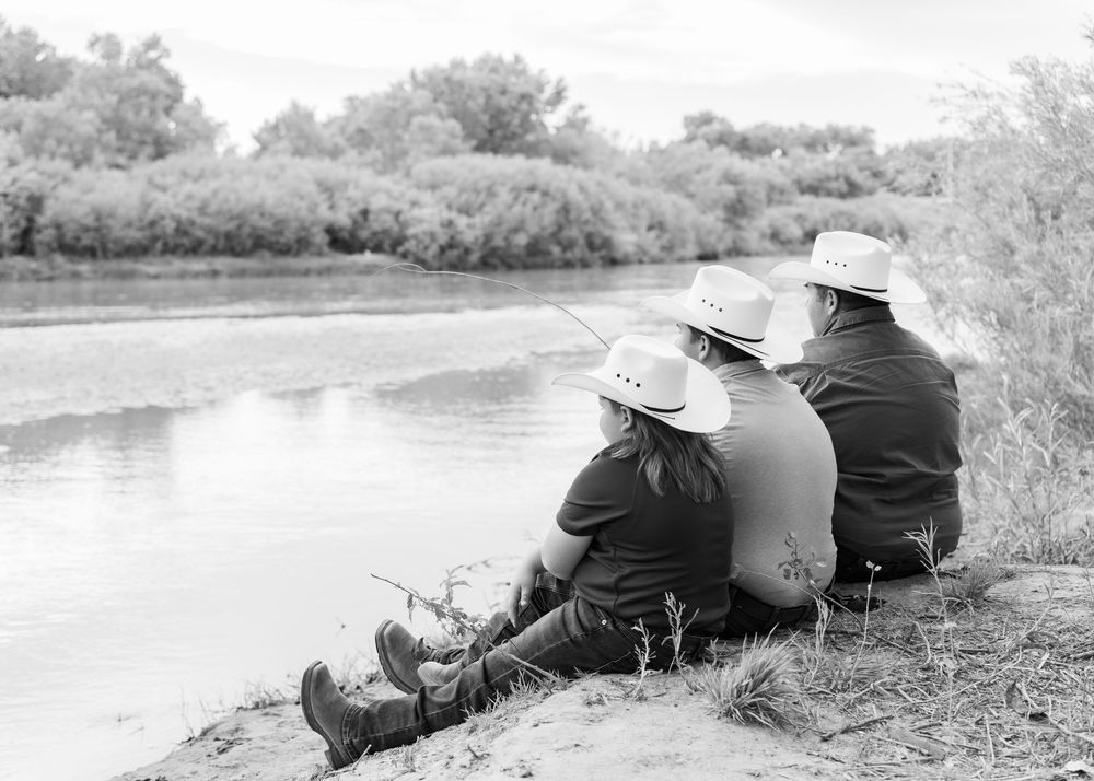 father and sons, cowboy hats, fishing, river, family photos, sitting on shore, black and white