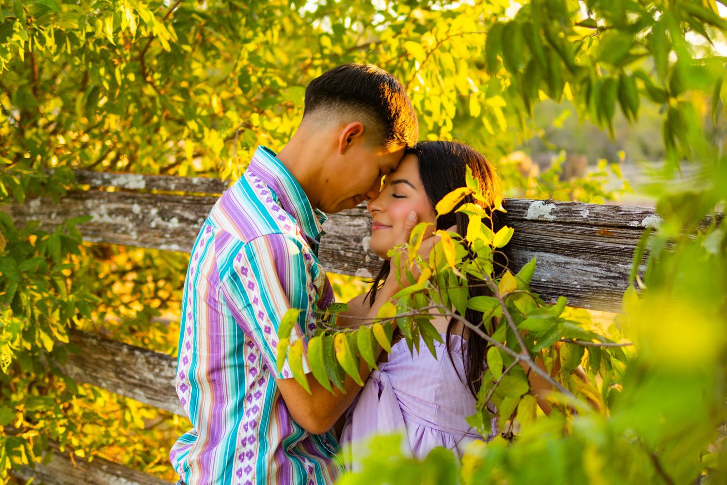 A romantic portrait surrounded by yellow sunflowers and autumn foliage in natural lighting.