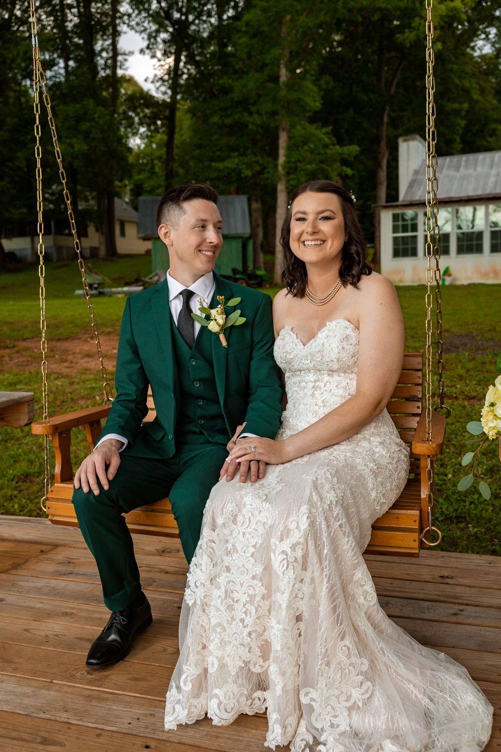 Newly husband and wife sitting on a swing looking happy