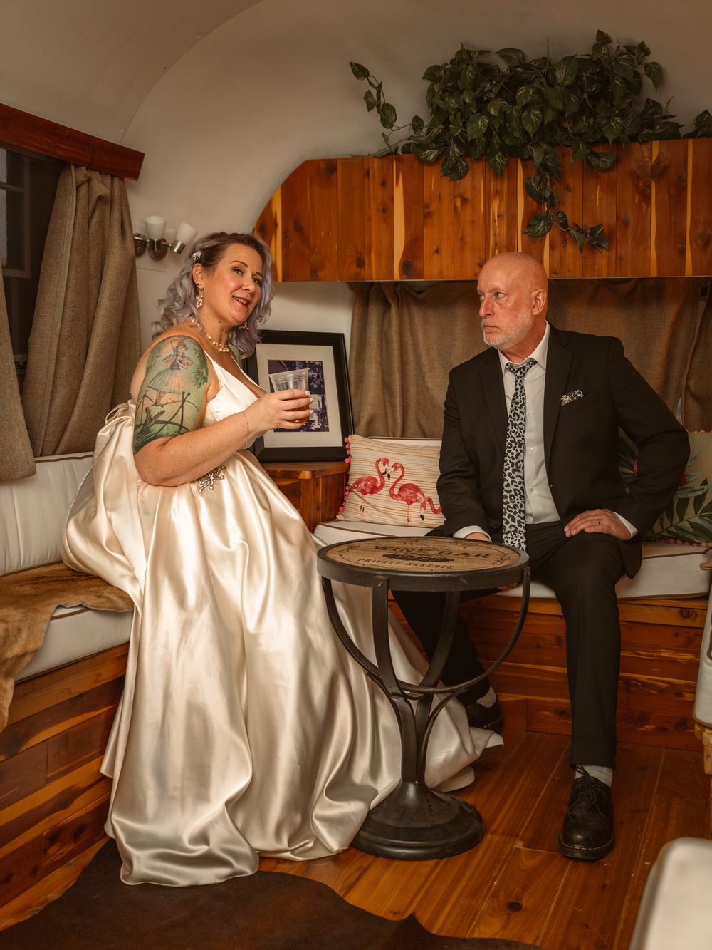 Classic wedding photography look of a couple inside a vintage airstream. Posing for their wedding photos.