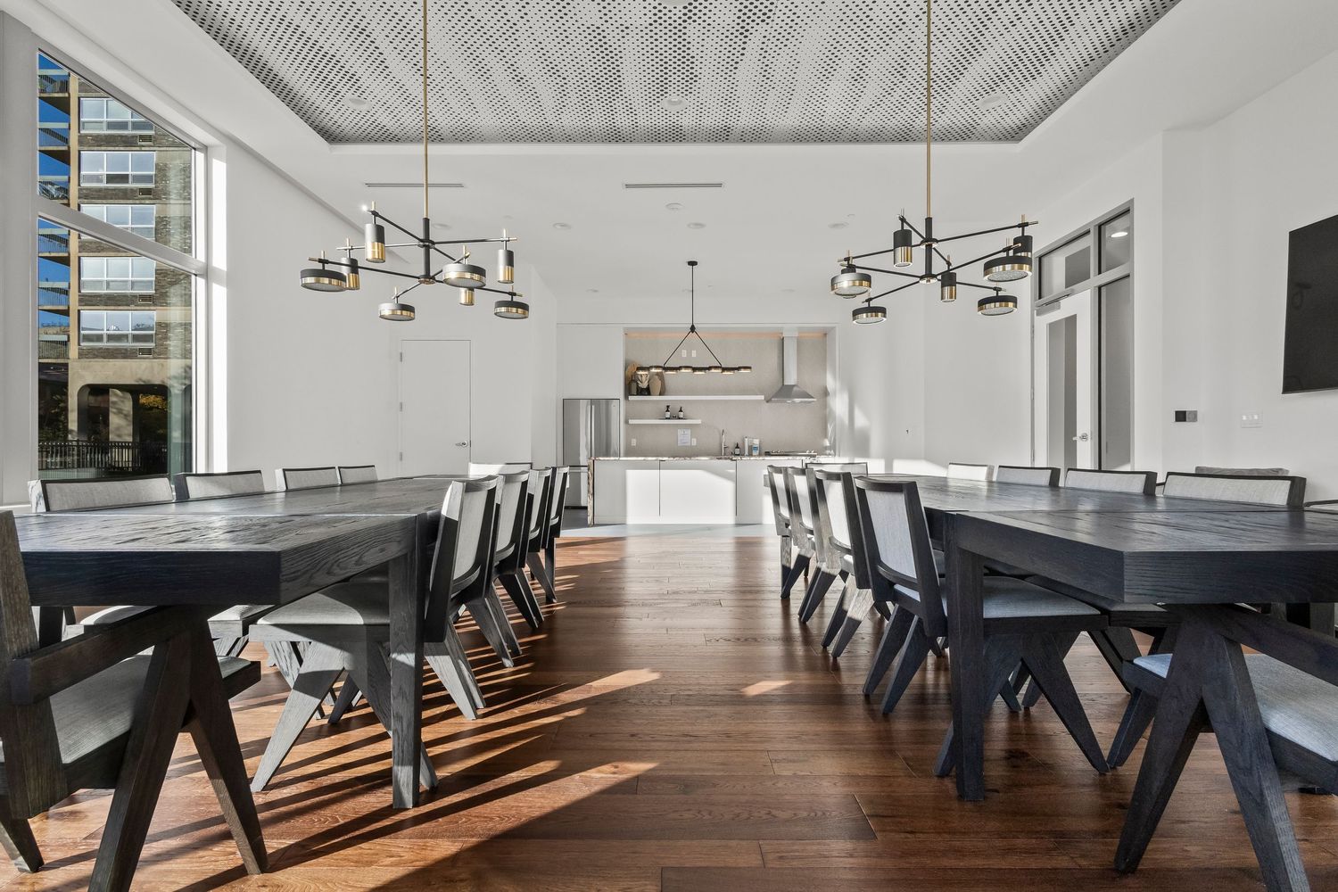 Restaurant dining room interior with long wood tables and pendant lighting, Wisconsin