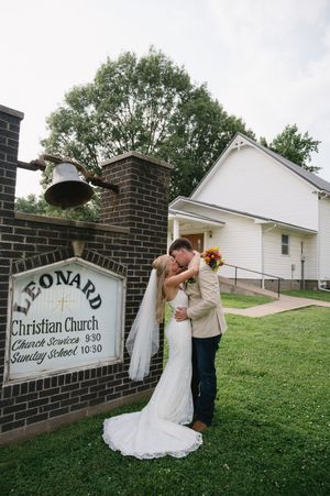 Bride and groom share a kiss outside the Leonard Christian Church.