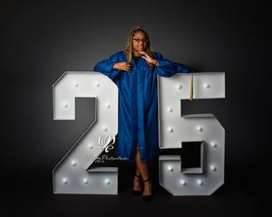 Graduating senior wearing Lexington High School senior cap & gown posed next to giant numbers; best photographer Lexington, SC senior photos