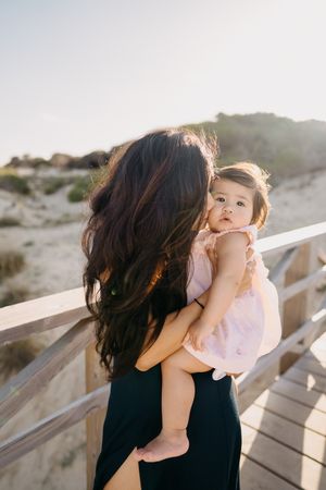 mom holding her daughter