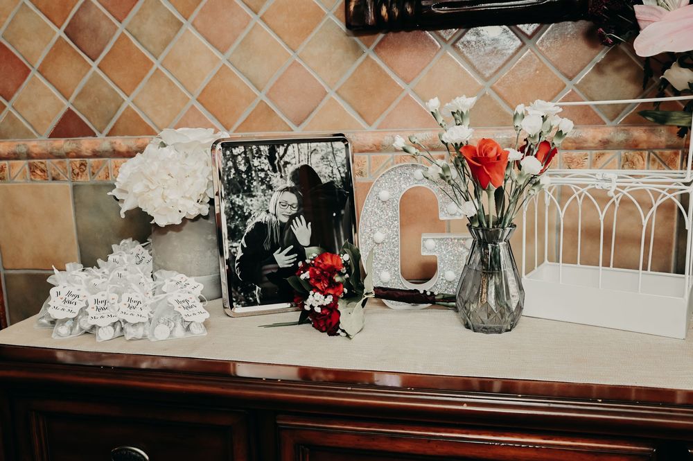 Elegant wedding decor arrangement with floral elements and terracotta accents.