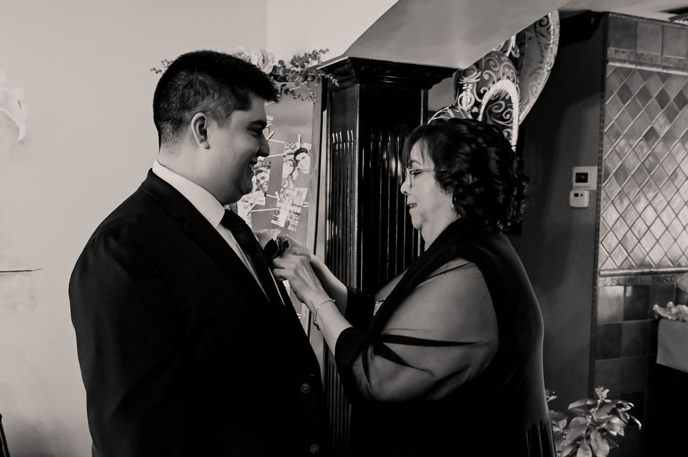 A black and white portrait of a couple during their wedding preparations.