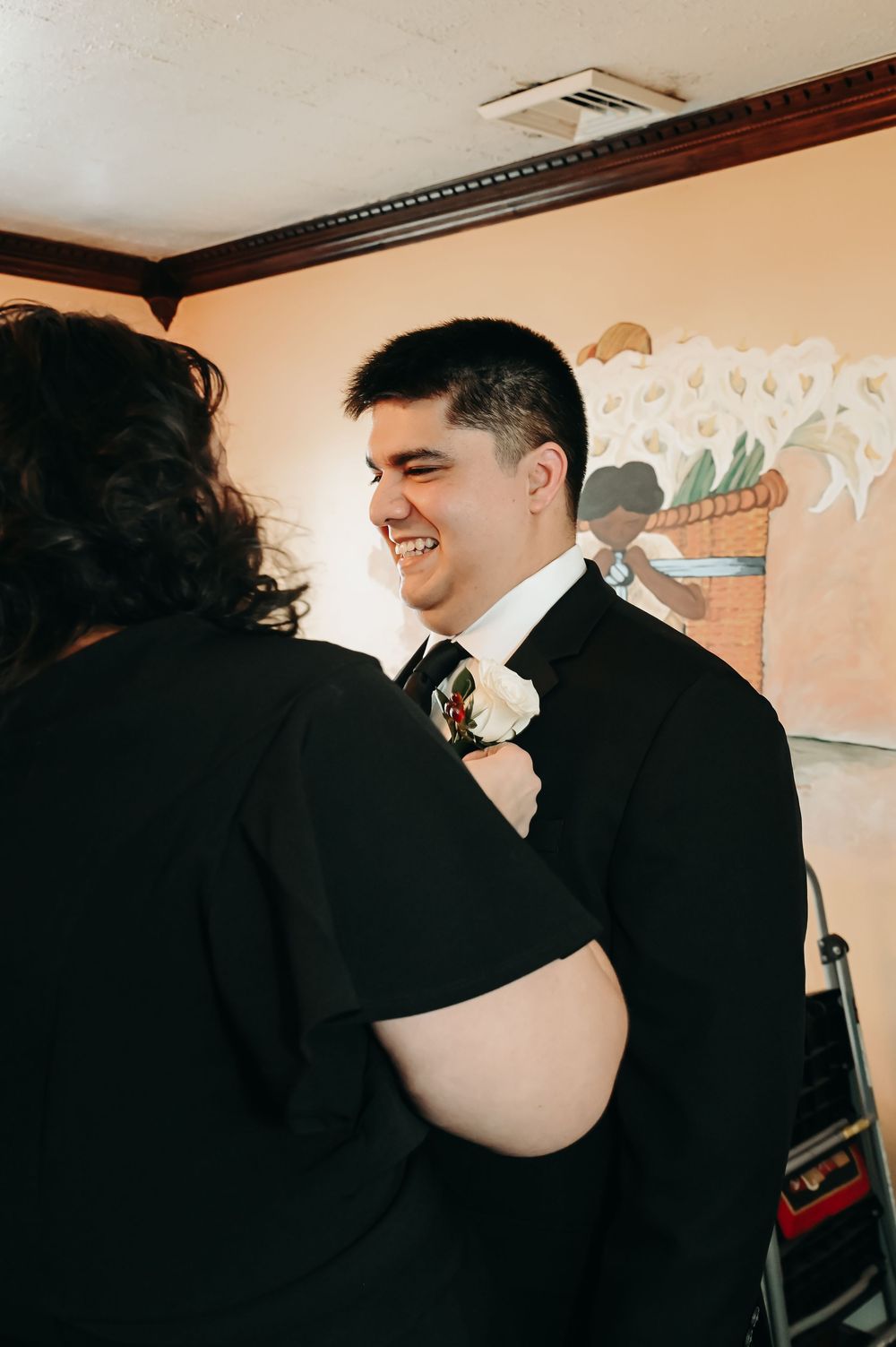 A couple shares an intimate moment while dressed in formal attire.