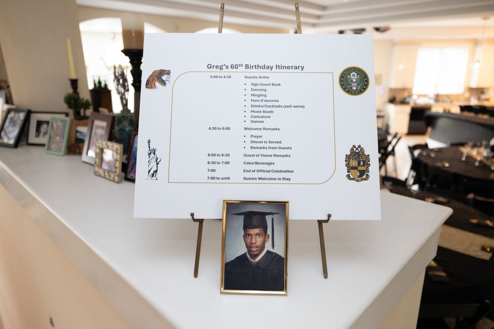 Graduation ceremony schedule displayed on easel with decorative elements.