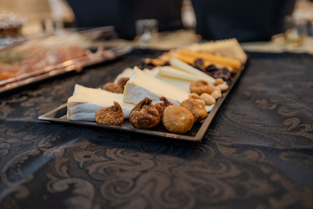 Assorted pastries and baked goods arranged on a rustic wooden serving platter.