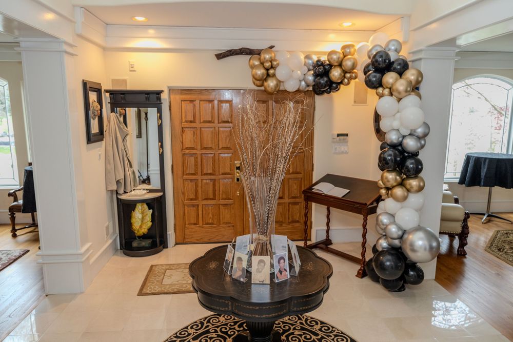 Elegant entrance hall with balloon arch decor and modern centerpiece display.