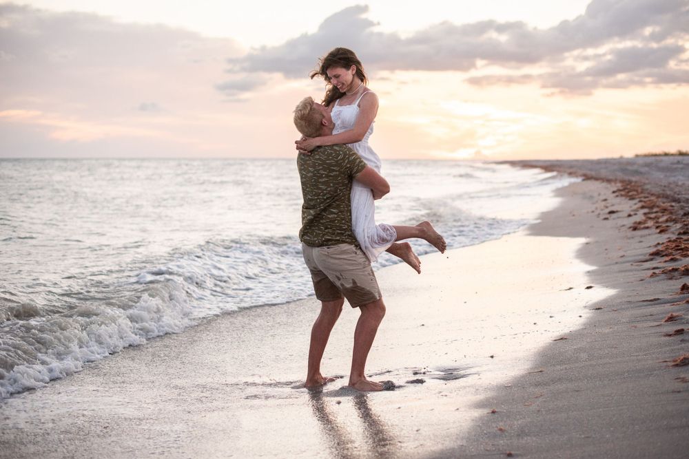 Couples photographer in Destin Florida capturing candid engagement moments during sunset