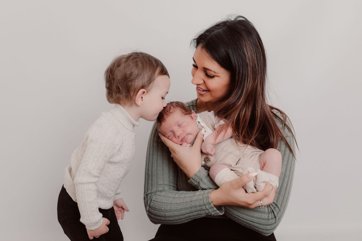 Sweet family interaction during studio portrait session with neutral colour palette. Photographer. Hull. East Yorkshire. Photography